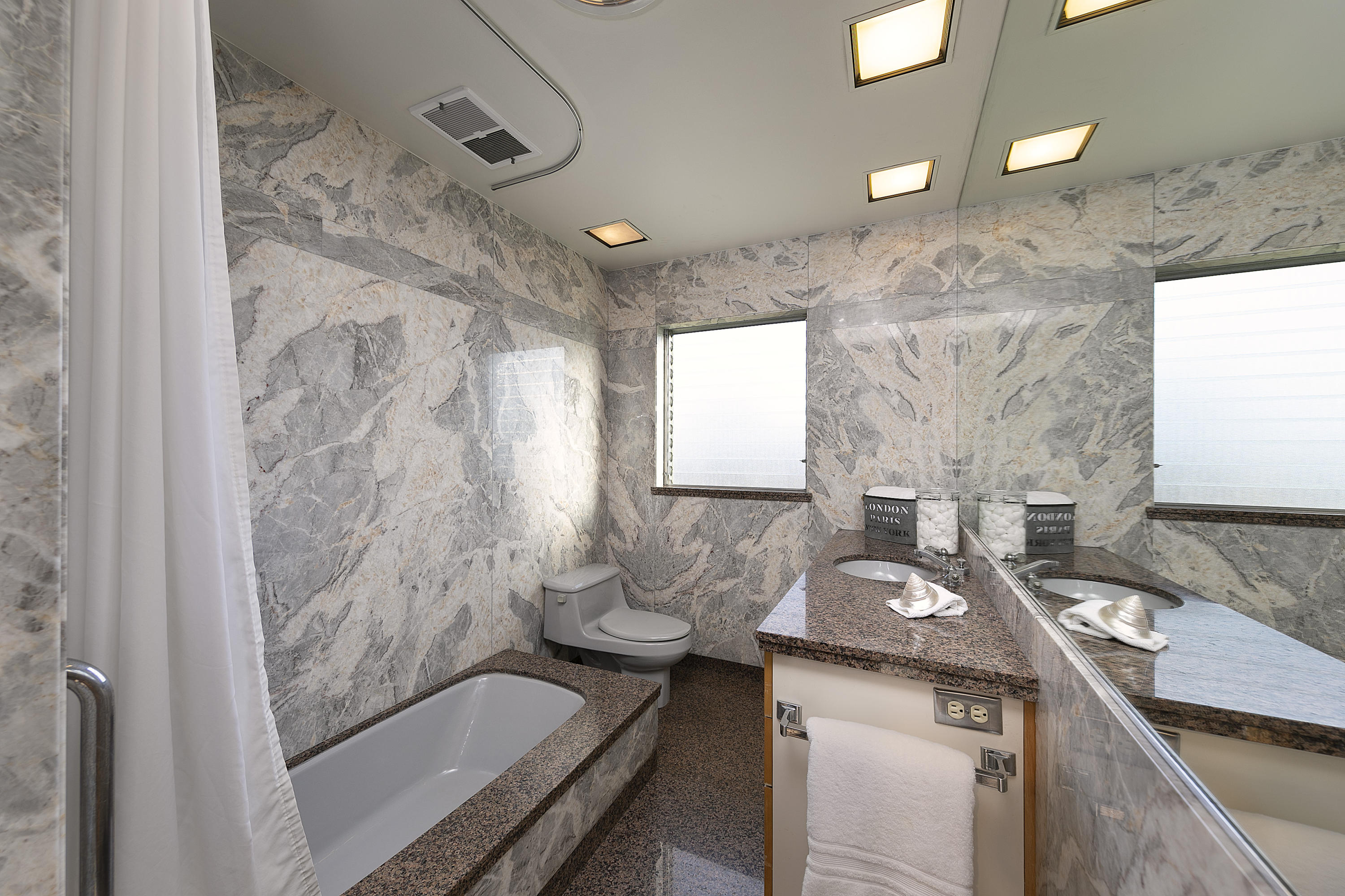 976 East Carrillo Road Santa Barbara, CA 93103 - Photo 15 of 22 a bathroom with a granite countertop sink a toilet and shower