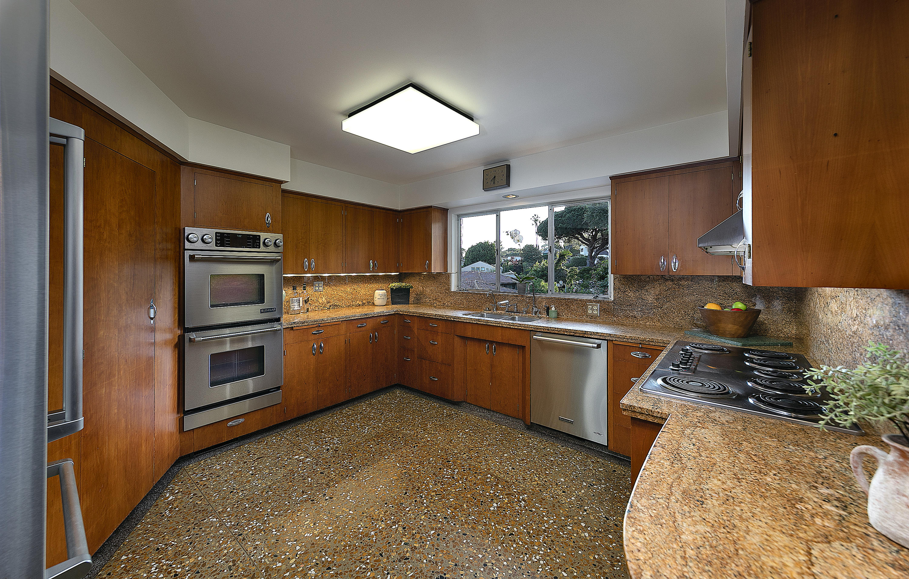 976 East Carrillo Road Santa Barbara, CA 93103 - Photo 7 of 22 a kitchen with stainless steel appliances kitchen island granite countertop a stove a sink and a microwave