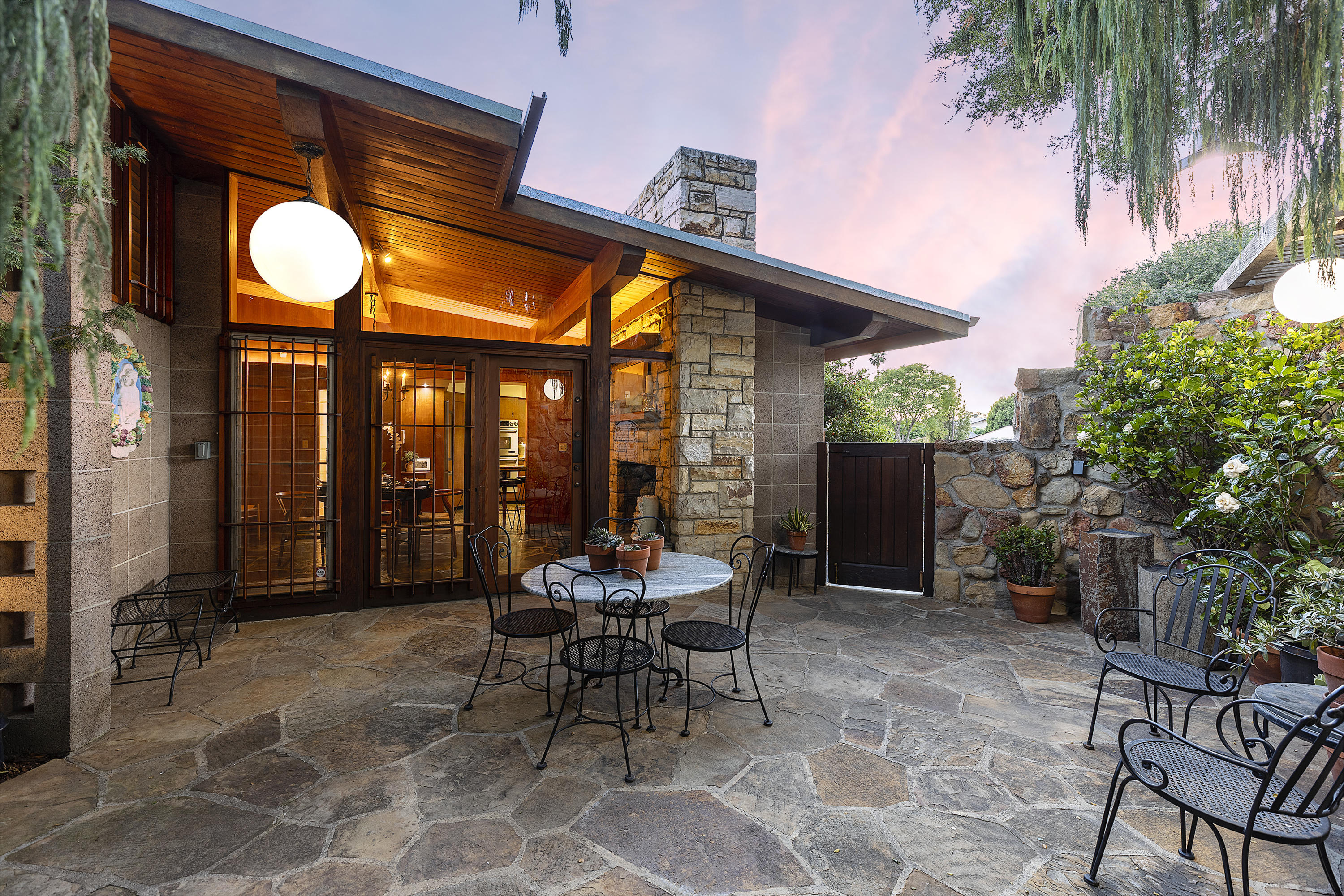 976 East Carrillo Road Santa Barbara, CA 93103 - Photo 9 of 22 a view of a patio with a table and chairs and potted plants