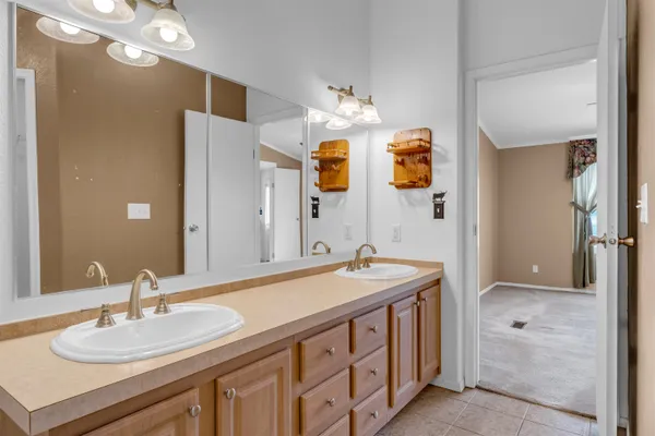 a bathroom with a sink double vanity granite and a mirror