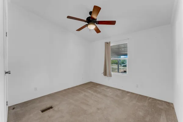 a view of room with window and ceiling fan
