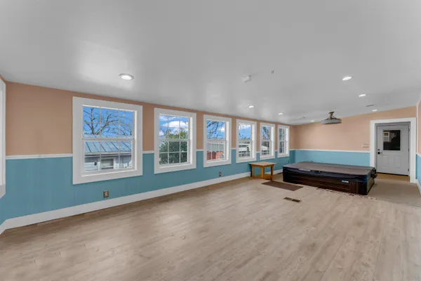 a room with pool table and windows