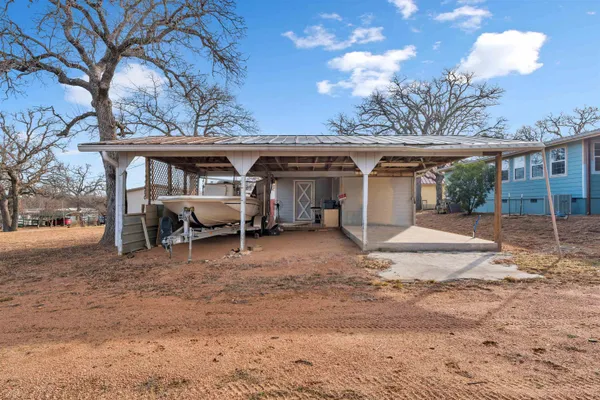 a view of a house with a yard and sitting area