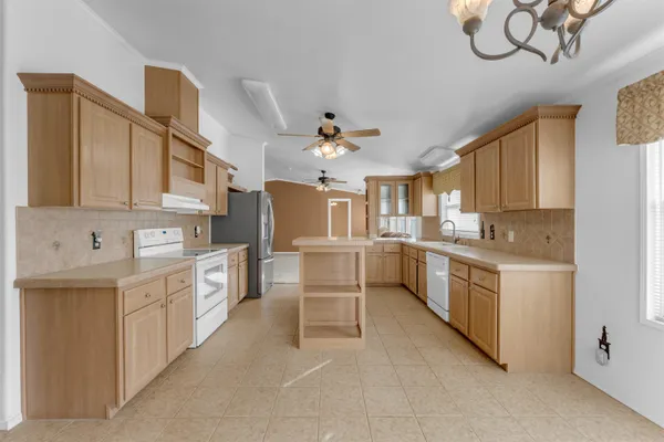 a kitchen with white cabinets and white appliances