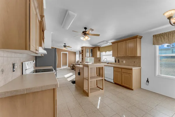 a kitchen with white cabinets and appliances