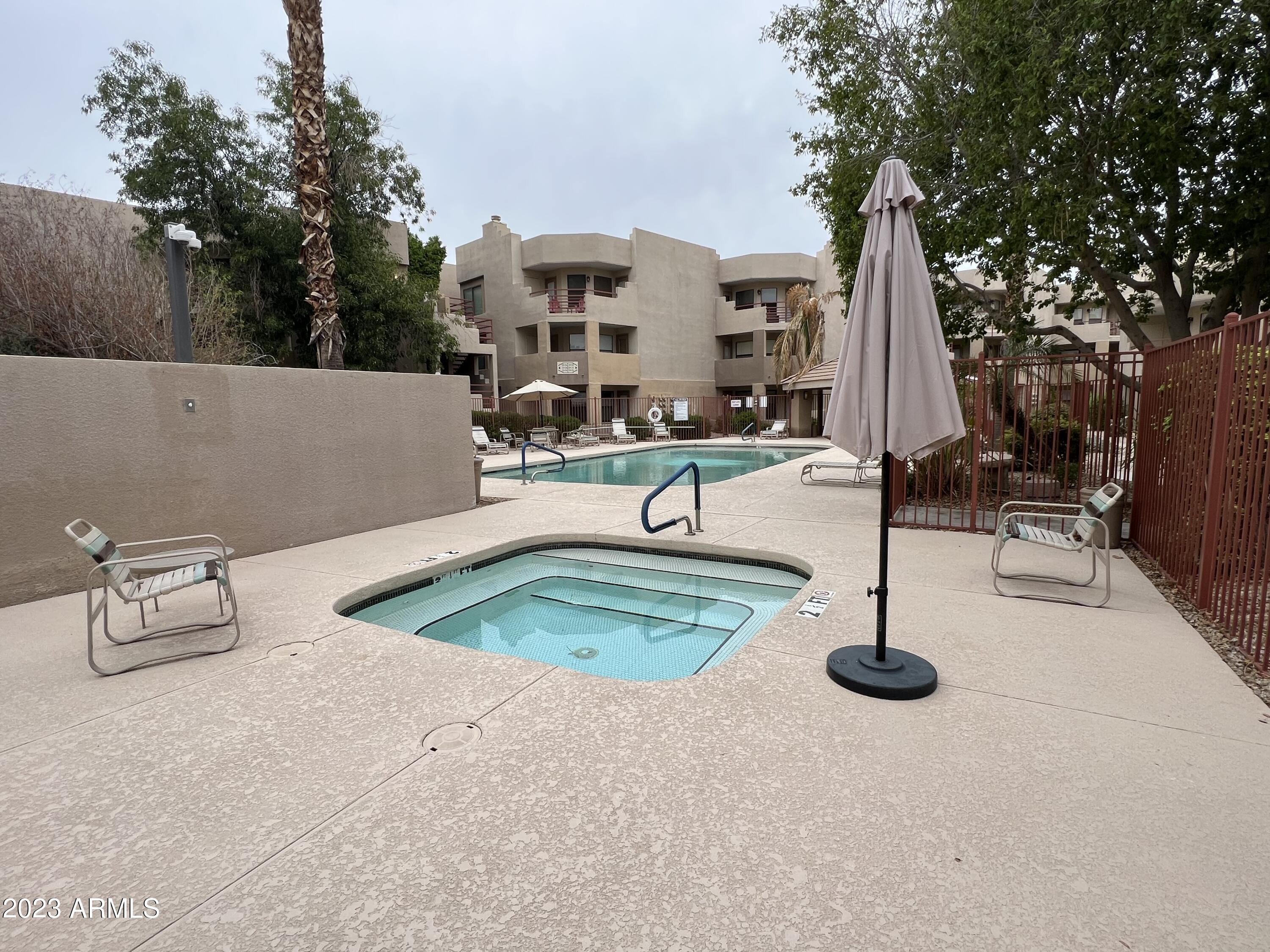 4850 East Desert Cove Avenue, Unit 105 Scottsdale, AZ 85254 - Photo 11 of 12 swimming pool view with a outdoor space