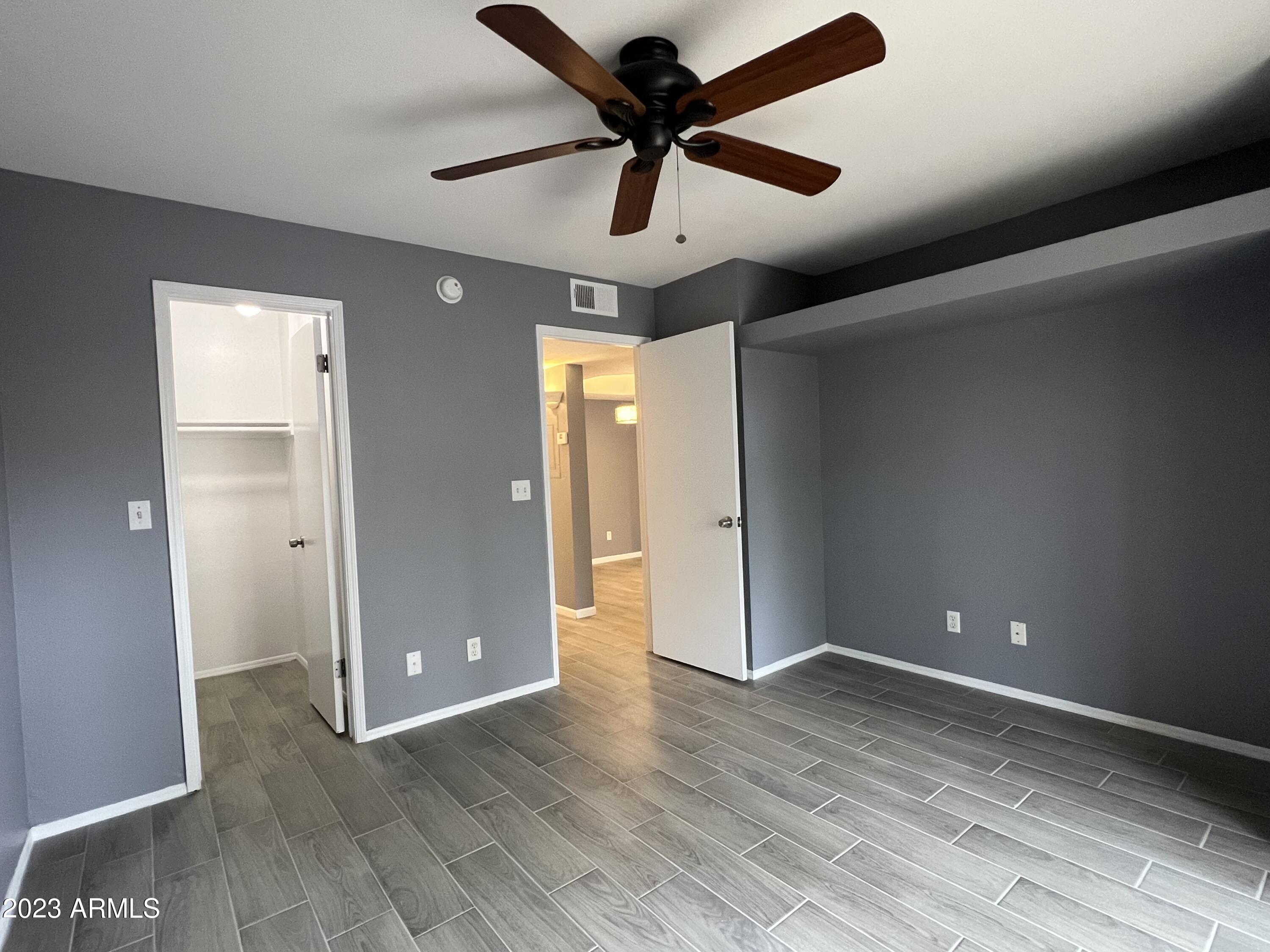 4850 East Desert Cove Avenue, Unit 105 Scottsdale, AZ 85254 - Photo 8 of 12 wooden floor in an empty room