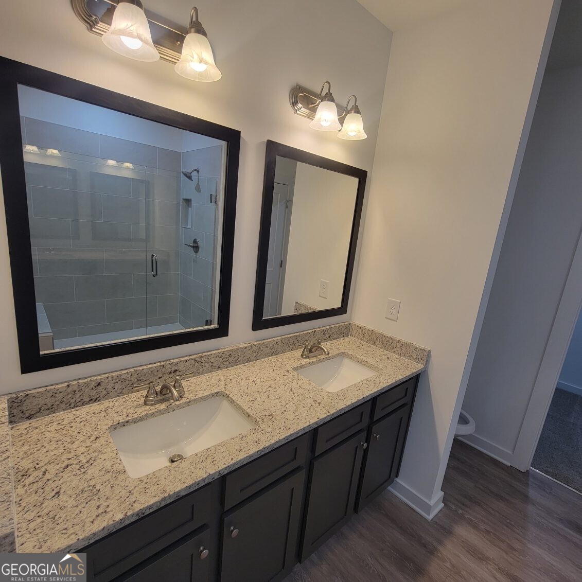 107 Breakwater Way Perry, GA 31069 - Photo 11 of 31 a bathroom with a granite countertop sink a large mirror and a shower