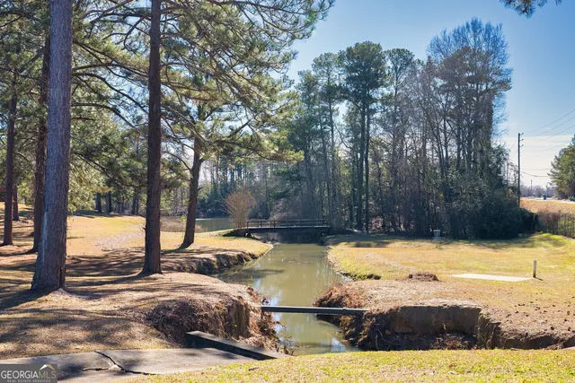 a view of swimming pool with trees in the background