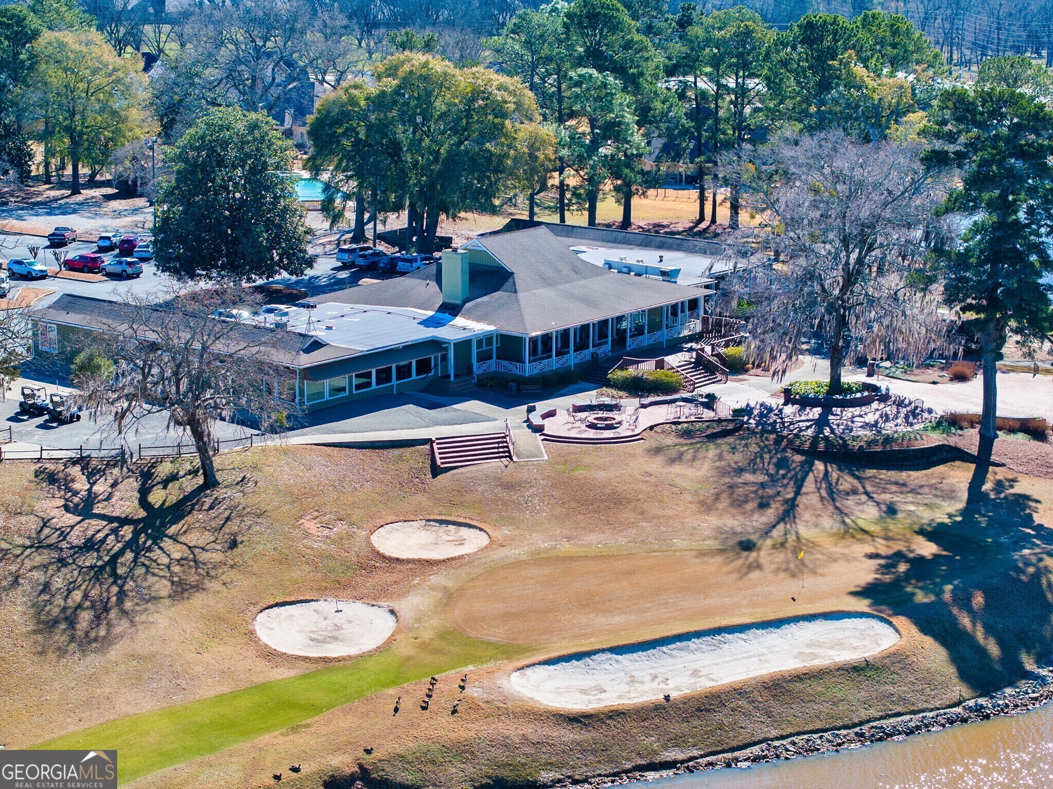 107 Breakwater Way Perry, GA 31069 - Photo 27 of 31 a view of a backyard with table and chairs couches under an umbrella