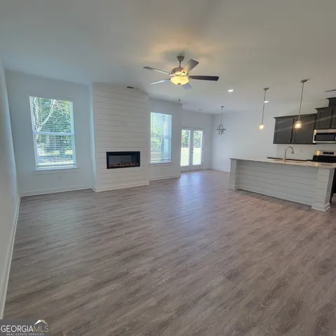 a view of a room with kitchen and a sink