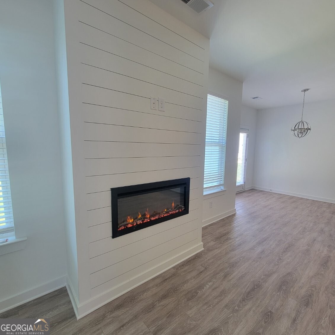 107 Breakwater Way Perry, GA 31069 - Photo 5 of 31 an empty room with wooden floor fireplace and windows