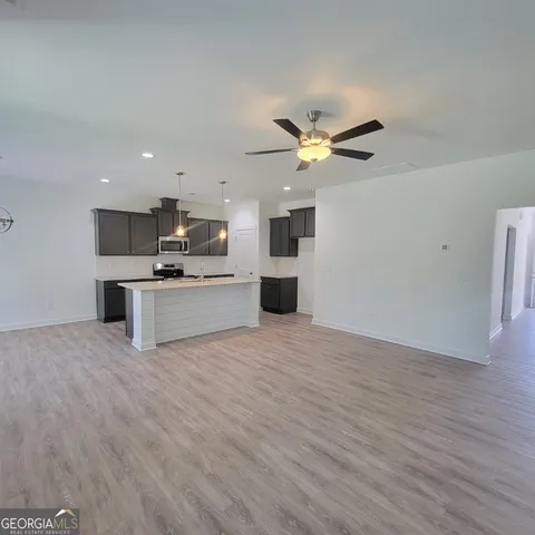 a view of a kitchen with a microwave and a stove top oven