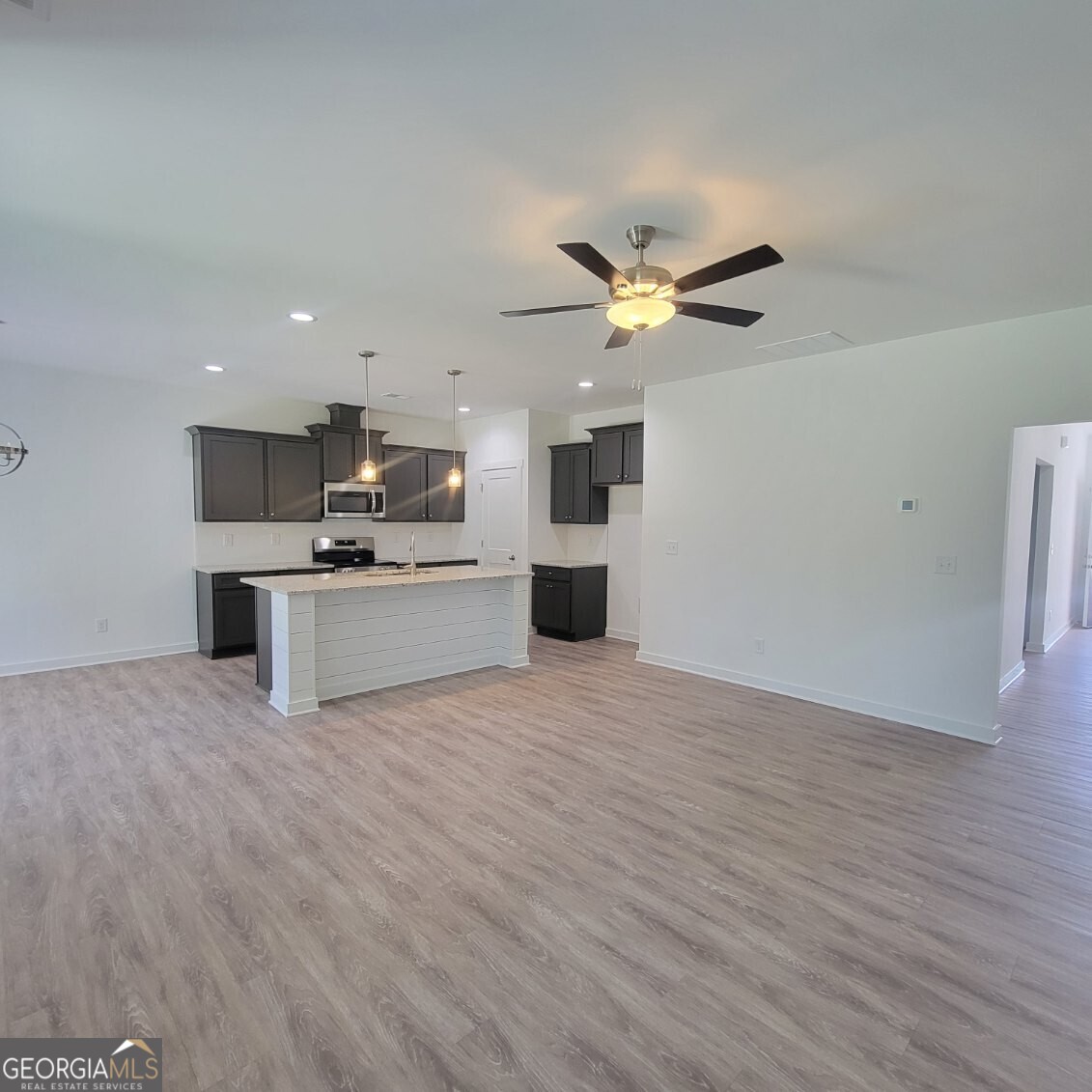107 Breakwater Way Perry, GA 31069 - Photo 6 of 31 a view of a kitchen with a microwave and a stove top oven