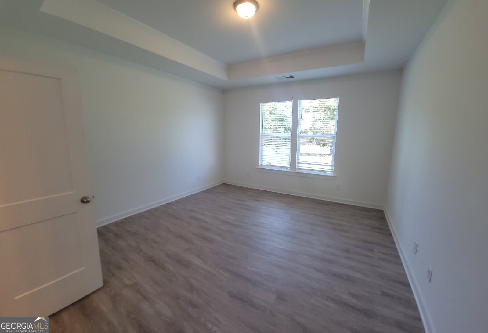 107 Breakwater Way Perry, GA 31069 - Photo 9 of 31 an empty room with wooden floor and windows
