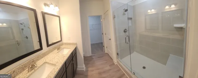 a bathroom with a tub shower and sink