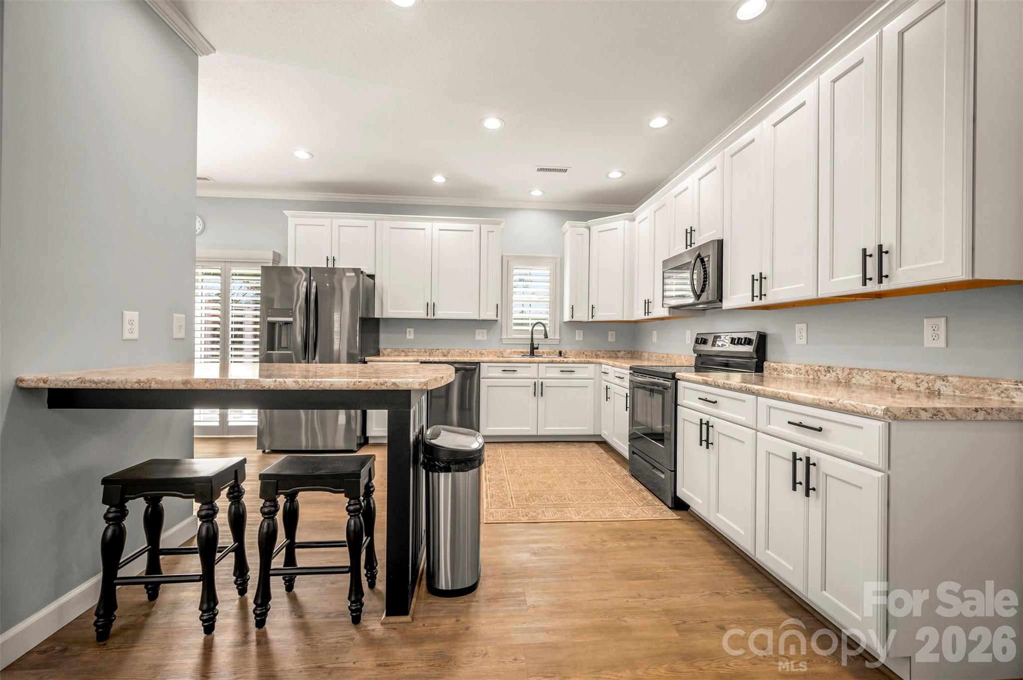 168 Nursery Road Forest City, NC 28043 - Photo 14 of 30 a kitchen with kitchen island granite countertop wooden cabinets a center island and stainless steel appliances