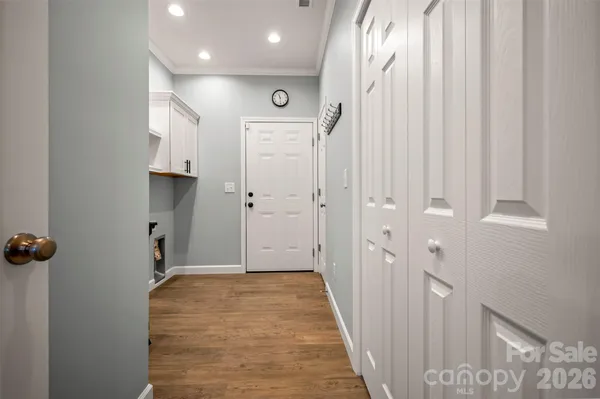 a view of a hallway with wooden floor and staircase