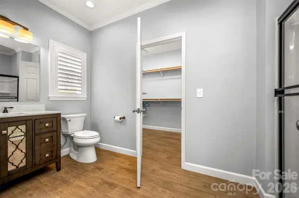 a bathroom with a toilet sink and a mirror