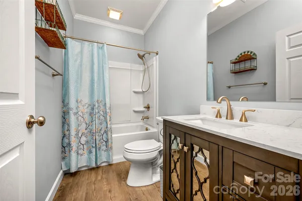a bathroom with a granite countertop sink a toilet and shower
