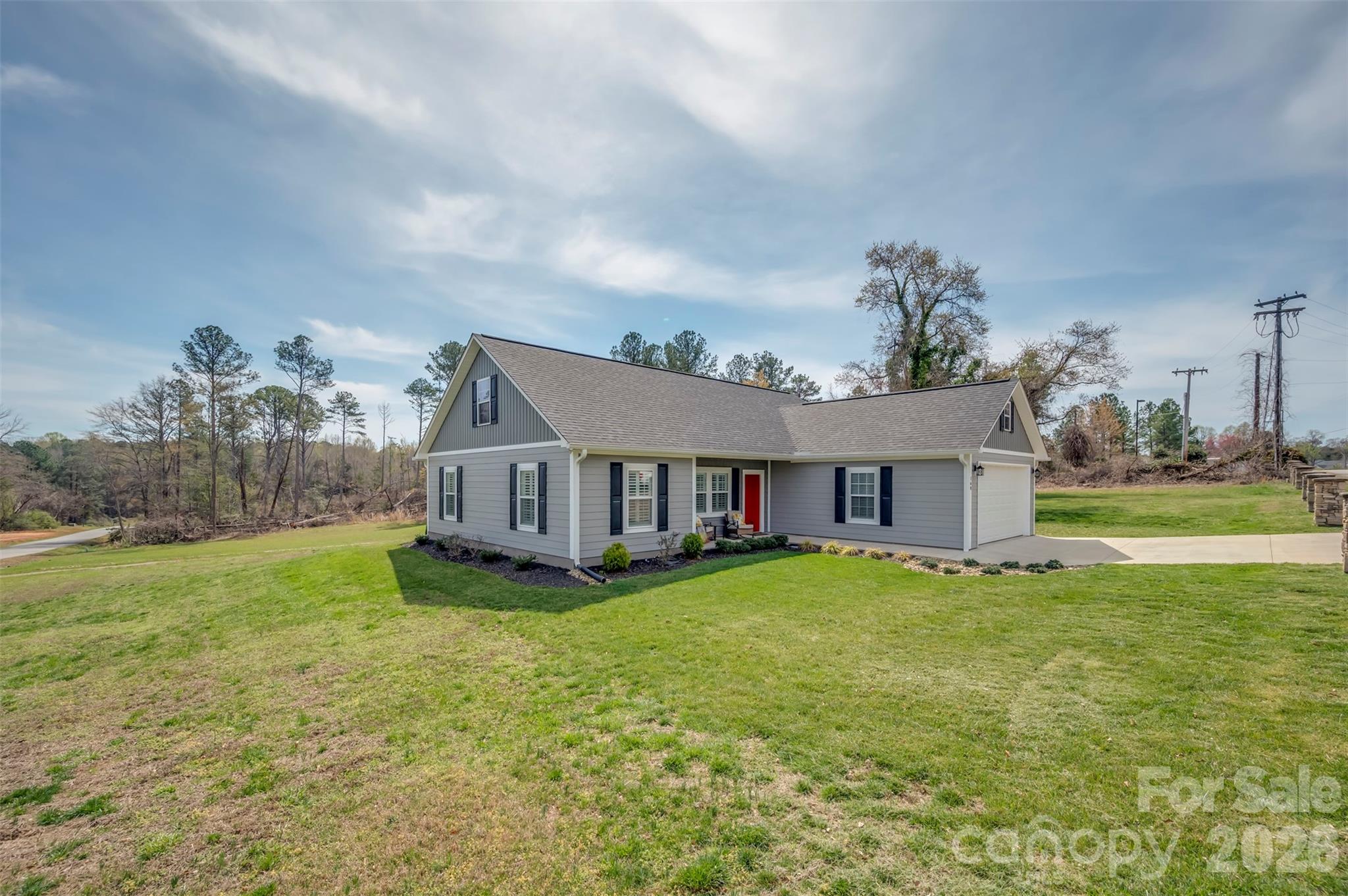 168 Nursery Road Forest City, NC 28043 - Photo 3 of 30 a view of a house with a big yard and a large tree