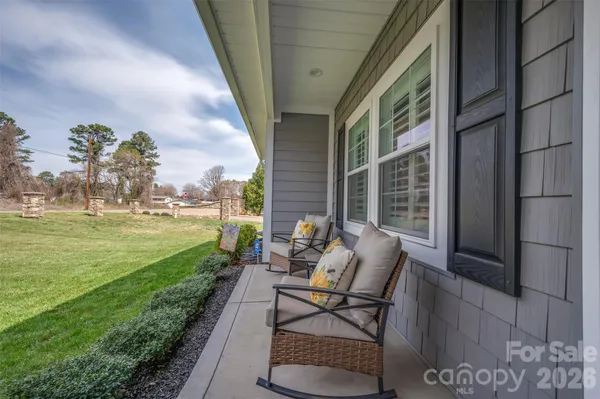 a view of a patio with a table chairs and garden