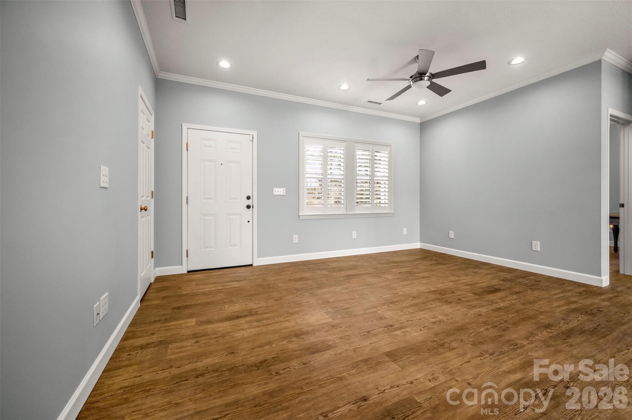 168 Nursery Road Forest City, NC 28043 - Photo 7 of 30 an empty room with windows and ceiling fan