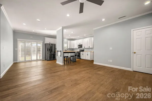 a view of kitchen with furniture and wooden floor