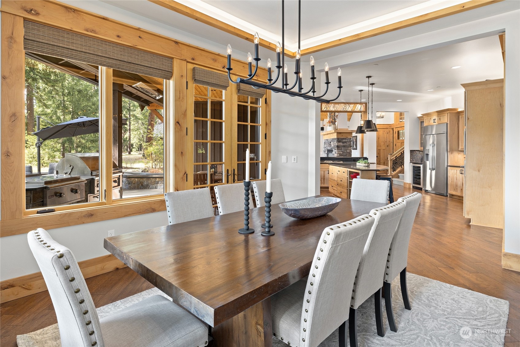1491 Larkspur Loop Cle Elum, WA 98922 - Photo 12 of 40 a dining room with wooden floor a chandelier a glass table and chairs