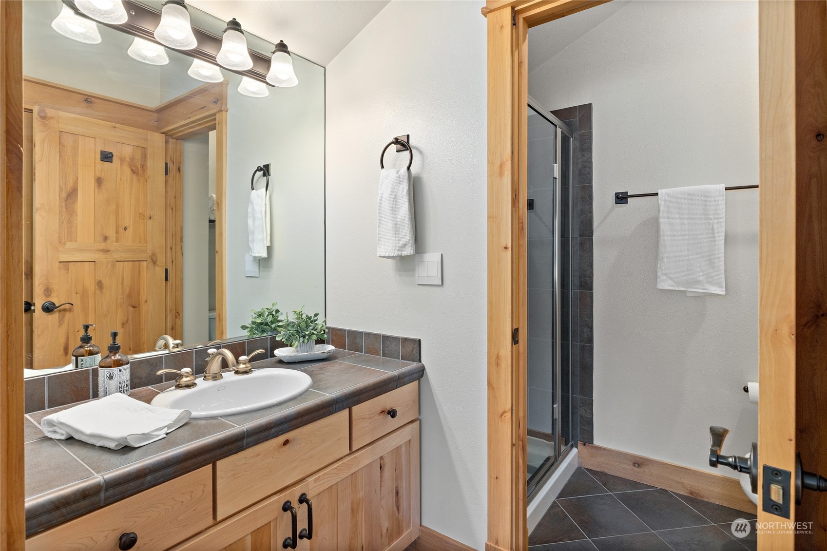 1491 Larkspur Loop Cle Elum, WA 98922 - Photo 25 of 40 a bathroom with a granite countertop sink a mirror and shower