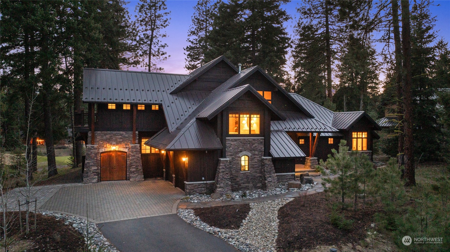 1491 Larkspur Loop Cle Elum, WA 98922 - Photo 35 of 40 a view of a house with brick walls and flower plants
