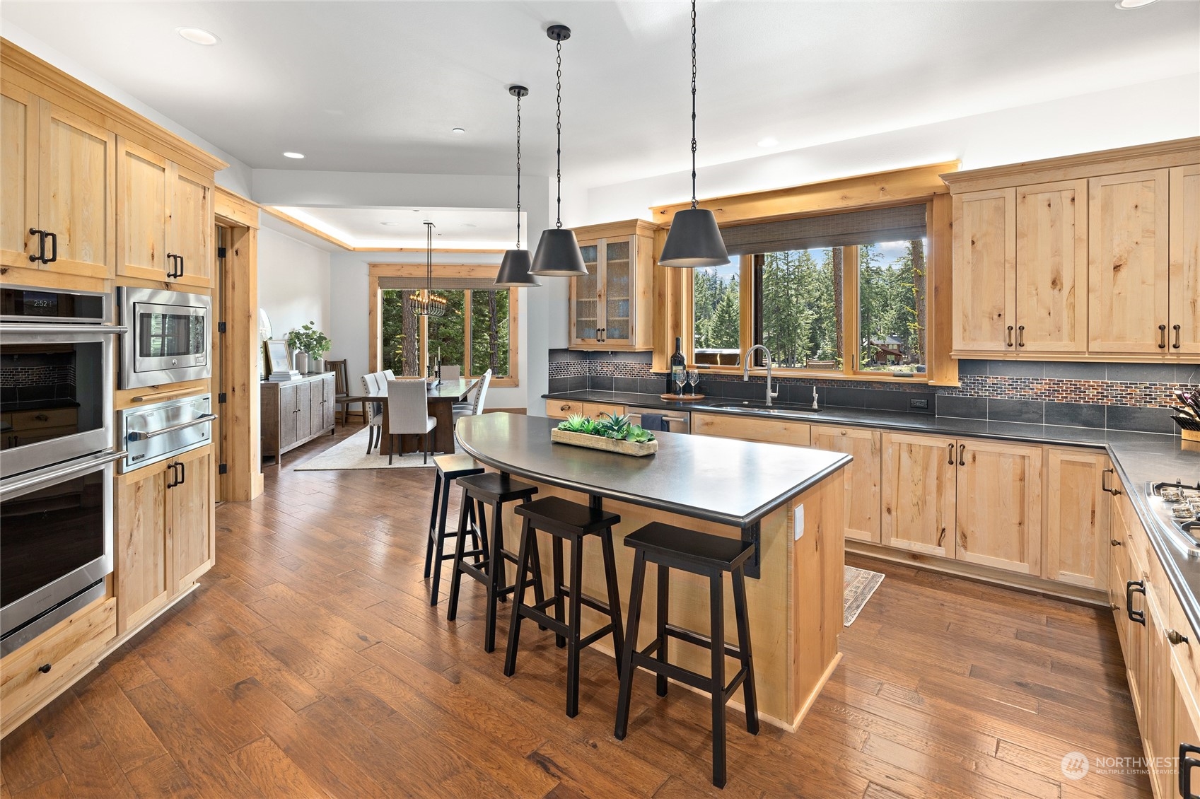 1491 Larkspur Loop Cle Elum, WA 98922 - Photo 10 of 40 a kitchen with stainless steel appliances granite countertop a stove top oven a refrigerator a sink and white cabinets with wooden floor