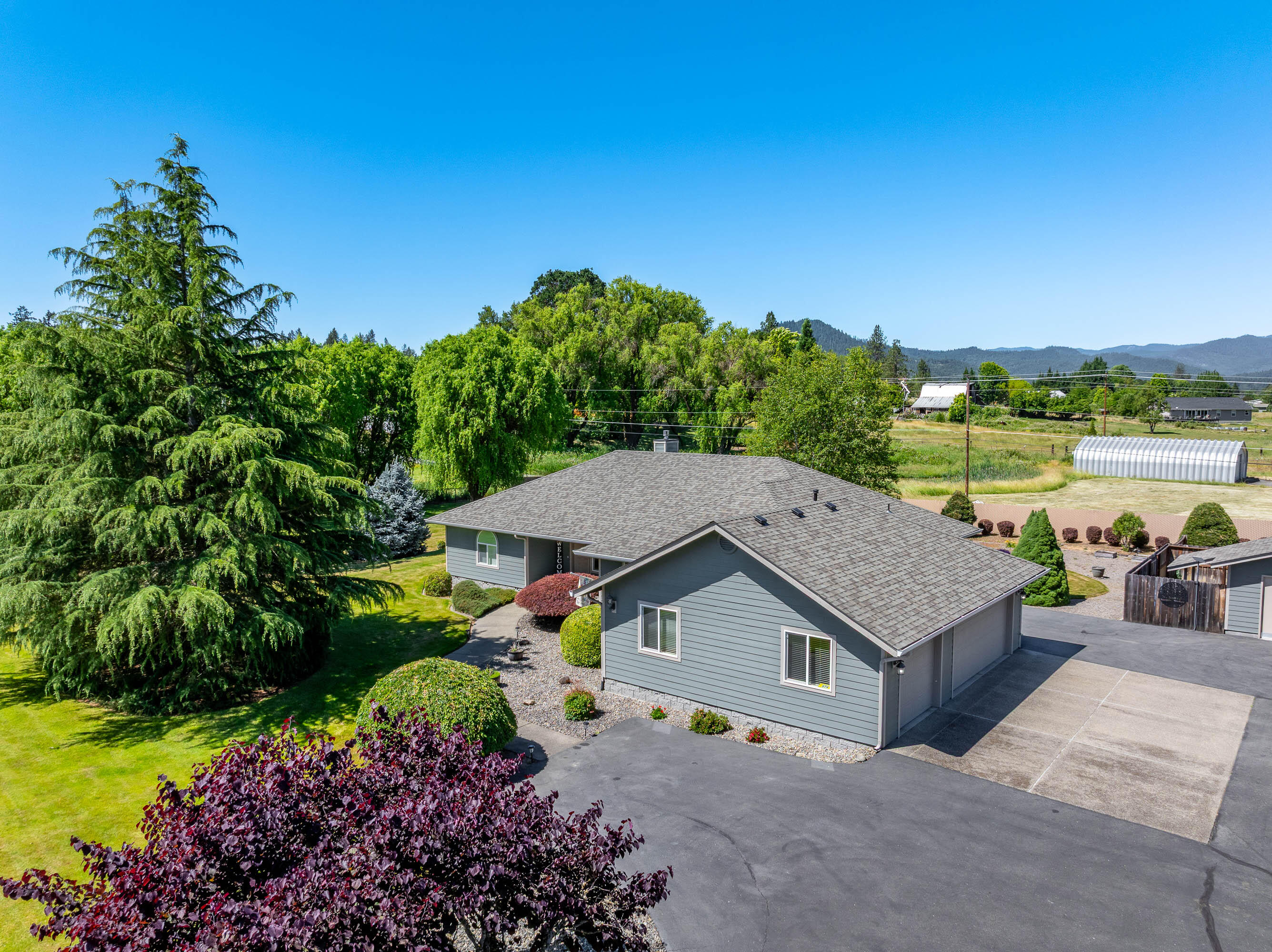 974 Felicia Lane Grants Pass, OR 97527 - Photo 35 of 36 a view of a house with a yard and outdoor seating