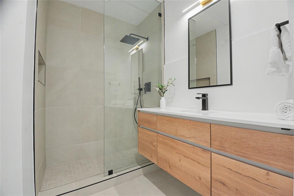 1111 Raiford Road, Unit 104 Carrollton, TX 75007 - Photo 21 of 30 a bathroom with a shower sink and mirror
