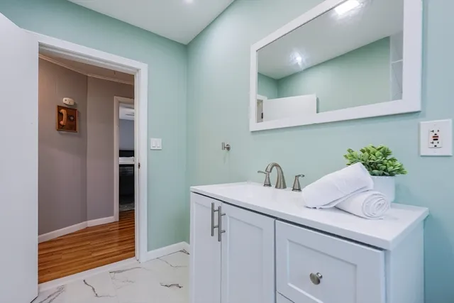 a bathroom with a sink and a mirror