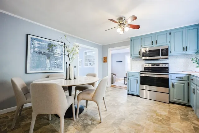 a view of kitchen with microwave stove top oven and cabinets