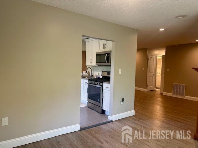 3 Farnham Square Parlin, NJ 08859 - Photo 11 of 31 a view of a kitchen with a fridge and wooden floor