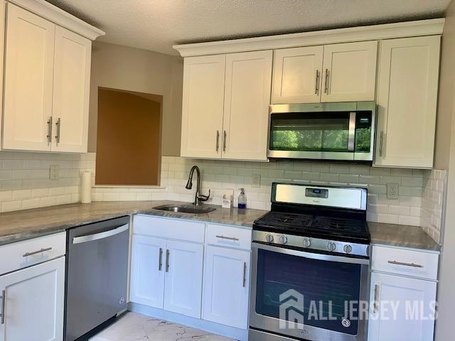 3 Farnham Square Parlin, NJ 08859 - Photo 14 of 31 a kitchen with stainless steel appliances granite countertop white cabinets a sink and dishwasher