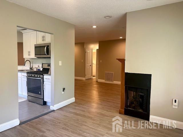 3 Farnham Square Parlin, NJ 08859 - Photo 18 of 31 a view of a hallway with wooden floor and a living room