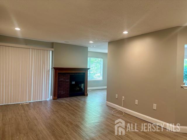 3 Farnham Square Parlin, NJ 08859 - Photo 10 of 31 an empty room with wooden floor and fireplace