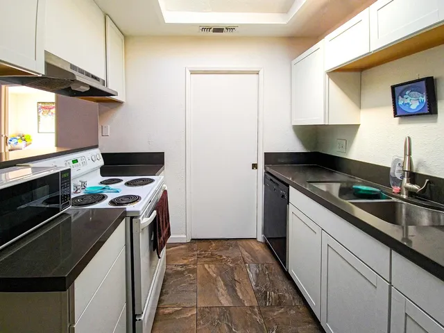 a kitchen with a stove and a sink