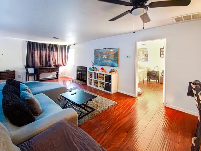 a living room with furniture and a wooden floor