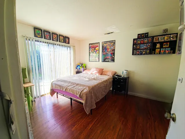 a bedroom with a bed and a book shelf