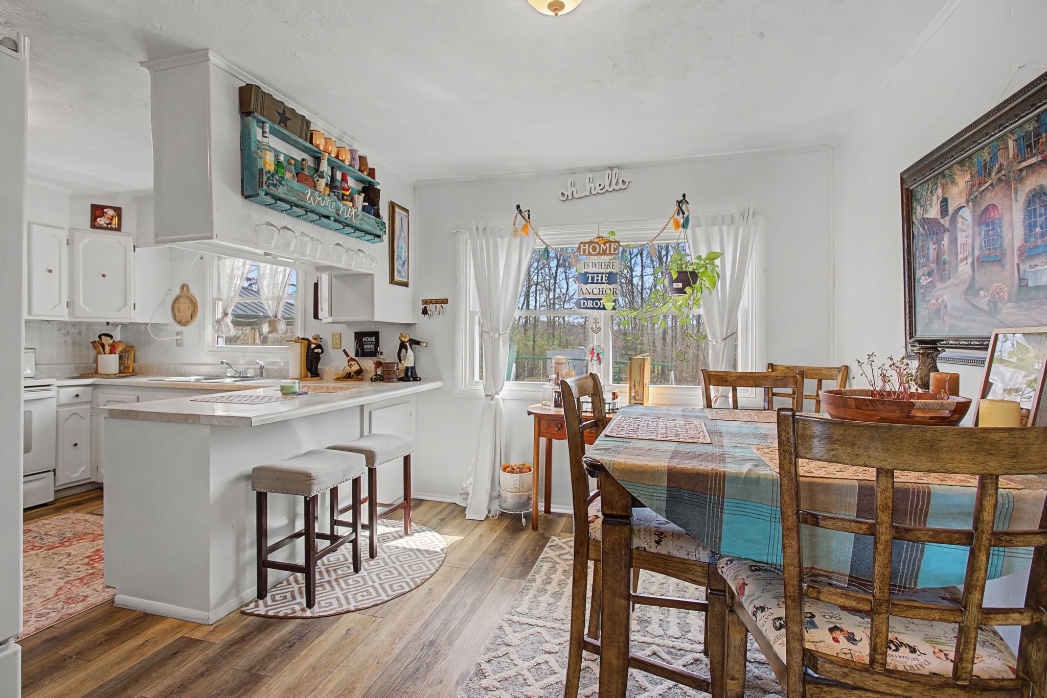 127 Rockhouse Road Hohenwald, TN 38462 - Photo 12 of 28 a kitchen with a table chairs stove and cabinets
