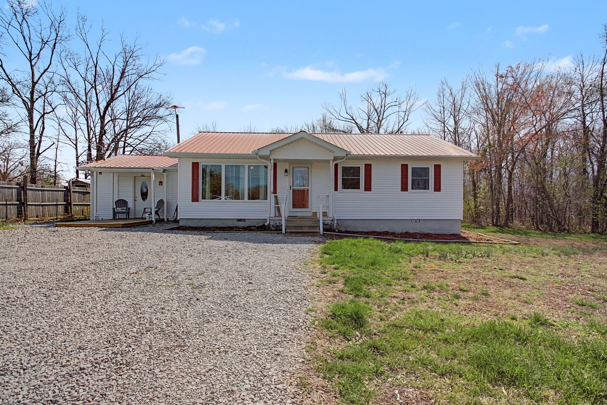 127 Rockhouse Road Hohenwald, TN 38462 - Photo 2 of 28 a front view of a house with a garden