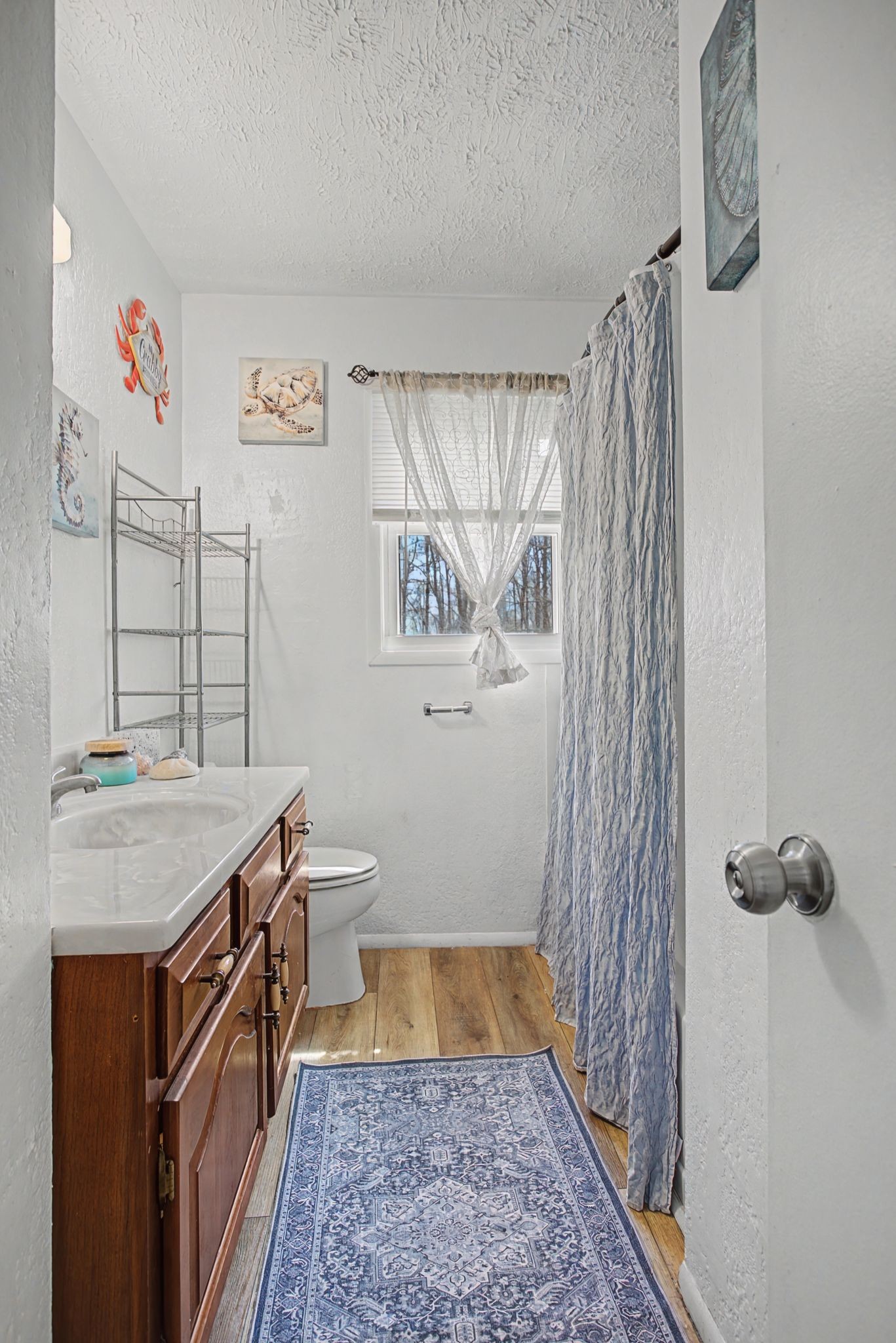 127 Rockhouse Road Hohenwald, TN 38462 - Photo 23 of 28 a bathroom with a granite countertop sink a toilet and shower