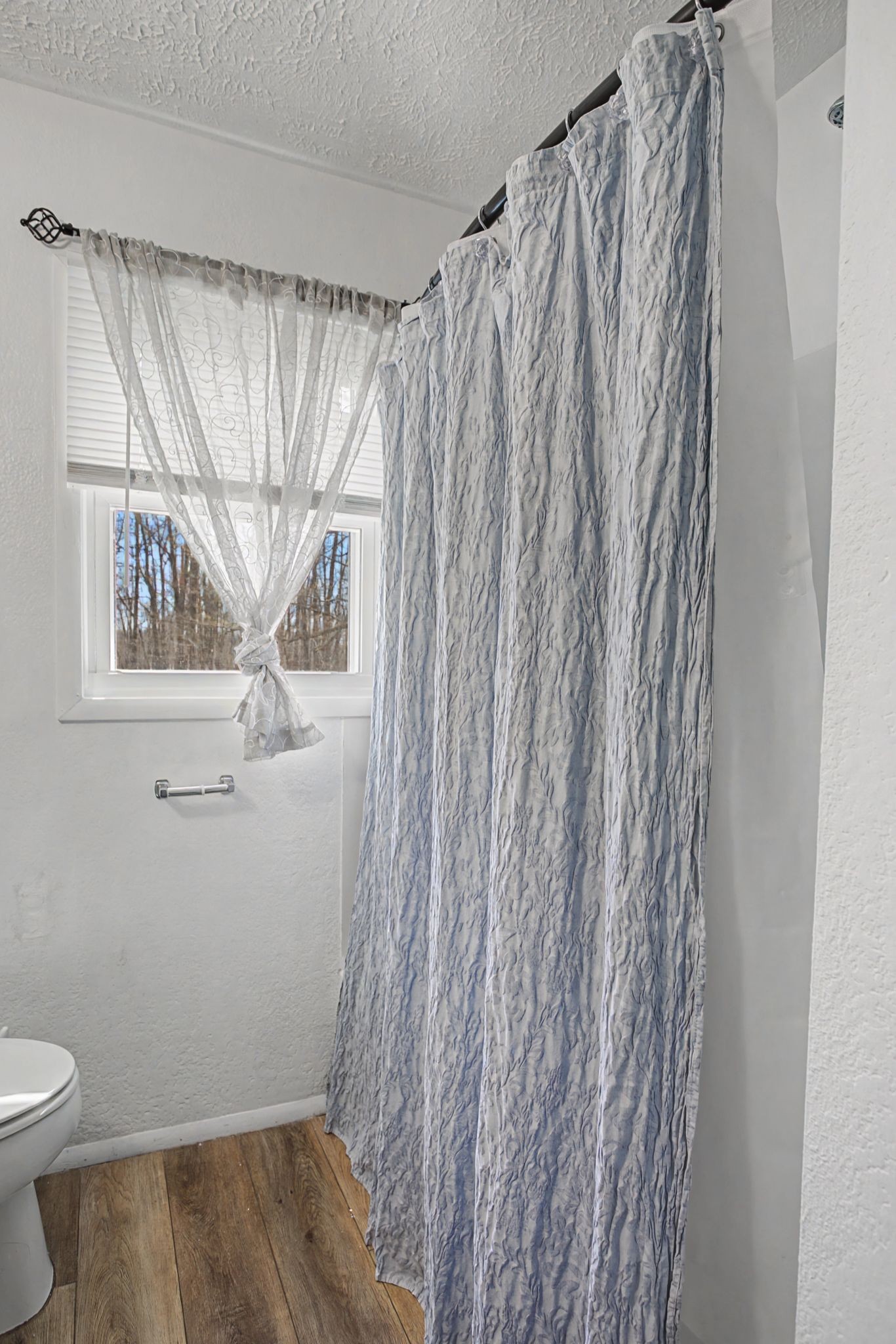 127 Rockhouse Road Hohenwald, TN 38462 - Photo 24 of 28 a bathroom with a shower curtain and sink