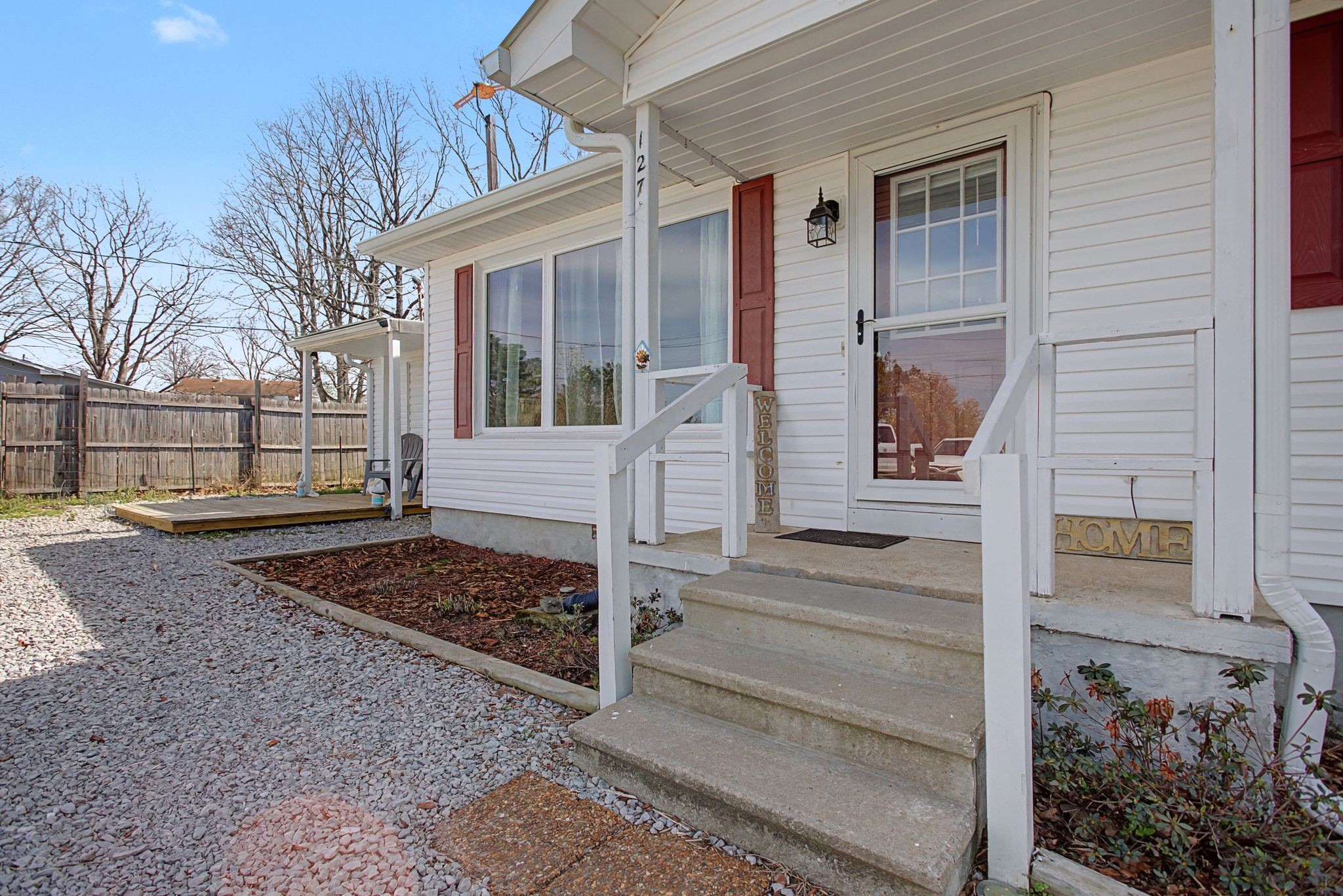 127 Rockhouse Road Hohenwald, TN 38462 - Photo 5 of 28 a front view of a house with lots of trees