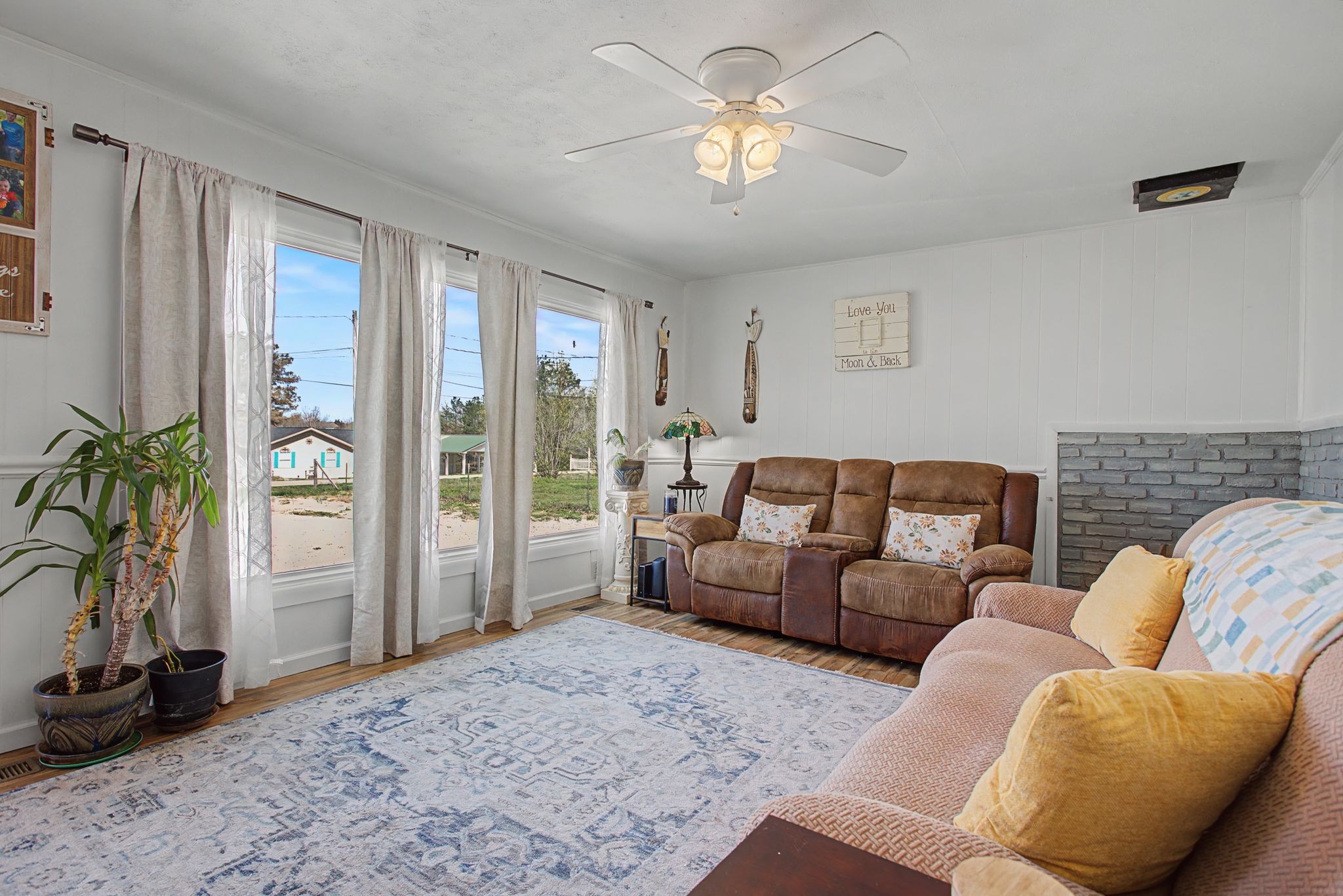 127 Rockhouse Road Hohenwald, TN 38462 - Photo 9 of 28 a living room with furniture potted plant and a large window