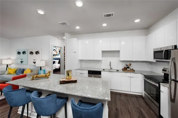 a kitchen with sink a stove and cabinets